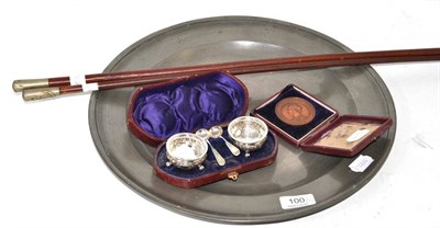 Lot 100 - Two swagger sticks, a pewter charger, cased silver salts and Victoria Calcutta medal