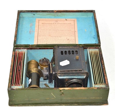 Lot 134 - A tinplate Magic Lantern and slides, cased