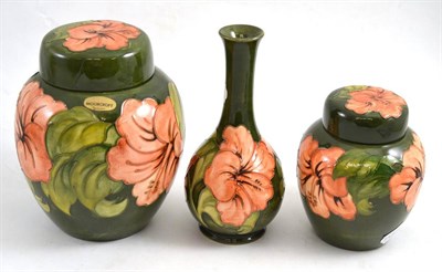 Lot 136 - Moorcroft ginger jars and covers and a bottle vase (3)