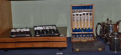 Lot 231 - A set of six silver coffee bean spoons, a set of six silver cake forks, cased set of plated...