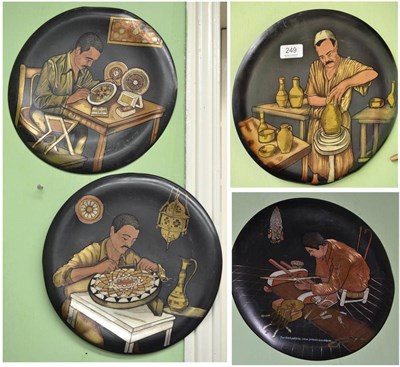 Lot 249 - Seven 20th century circular metal plaques decorated with Eastern tradesmen