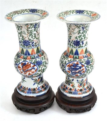 Lot 292 - A pair of Chinese Wucai porcelain vases, Wanli reign marks but probably later, painted with dragons