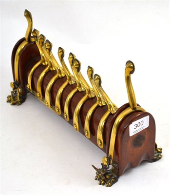 Lot 300 - A Regency mahogany and brass mounted stirrup stand complete with five pairs of spurs and raised...