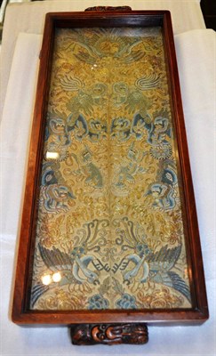 Lot 355 - A Chinese hardwood tray inset with an embroidered silk panel depicting various birds and...