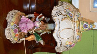 Lot 370 - A German porcelain figural lamp, the base modelled with four dancers and the shade with...