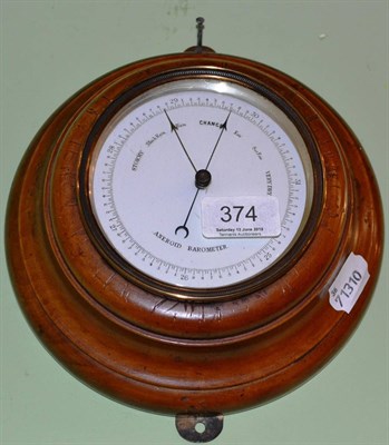 Lot 374 - A walnut aneroid barometer with plain turned case