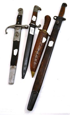 Lot 376 - Three various bayonets with scabbards and a Middle-Eastern ornamental knife with carved wood sheath