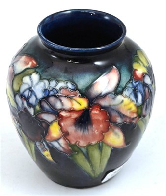 Lot 385 - A Walter Moorcroft Orchid and Spring Flowers pattern vase, on a blue ground, impressed factory...