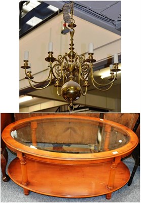 Lot 1046 - A reproduction yewwood oval glass coffee table and a brass Dutch style chandelier