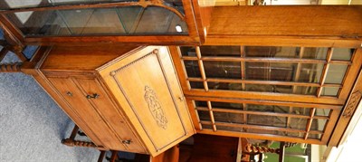 Lot 1059 - An Edwardian oak bureau bookcase with glazed cabinet top and astragal glazing