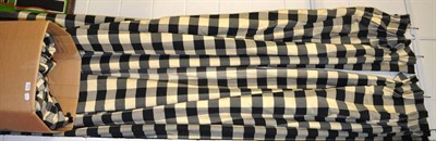 Lot 1079 - Three pairs of black and white checked curtains, lined and interlined with black bobble trim, 255cm