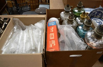 Lot 1106 - Six oil lamps, box of chimney fittings and a box of shades