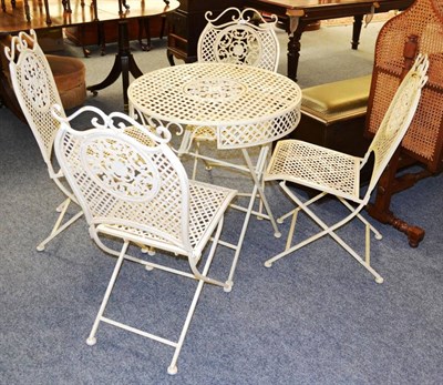 Lot 1147 - An ivory painted folding metal conservatory table and four chairs