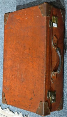 Lot 1166 - A vintage tan leather suitcase with brass locks