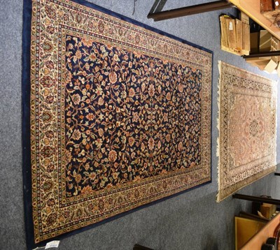 Lot 1177 - Machine made carpet of Oriental design, the indigo field with an allover design of palmettes...