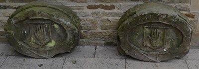 Lot 1205 - A pair of carved sandstone crests, bearing hand within a belted motto, ";Regi Patriaque ???"