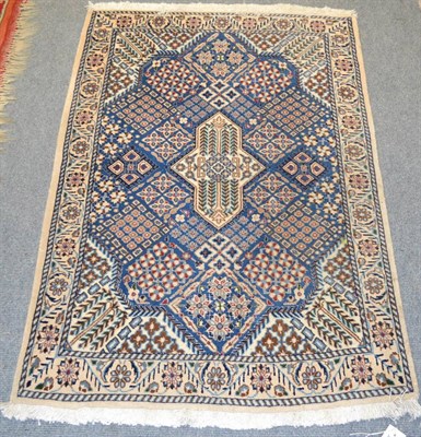 Lot 1287 - Nain rug, Central Persia, the mid indigo diamond lattice field with central medallion framed by...