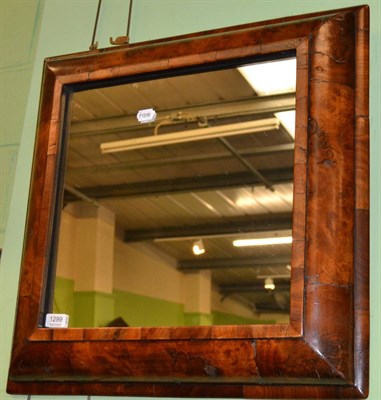 Lot 1299 - A walnut cushion framed mirror in 17th century style