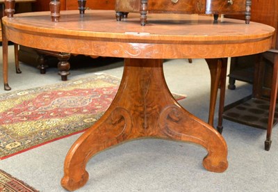 Lot 1316 - A Continental walnut loo table, the circular radially veneered top raised on a three-sided...