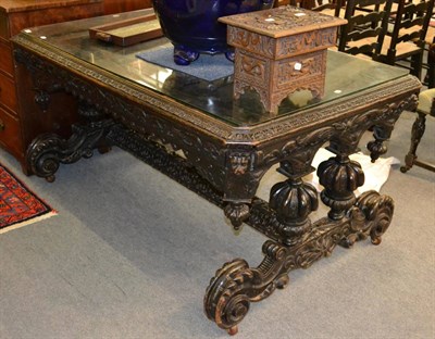 Lot 1337 - A large 19th century ebonised carved oak table on stretcher base