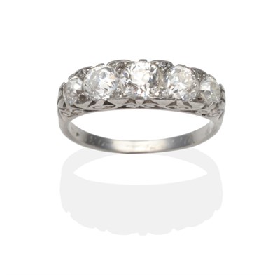 Lot 293 - An Art Deco Diamond Half Hoop Ring, five graduated old cut diamonds with old cut diamond accents in