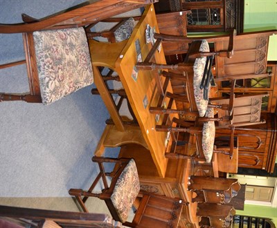 Lot 1395 - A modern oak table on stretcher base with a shaped top and a set of six modern Gothic style...