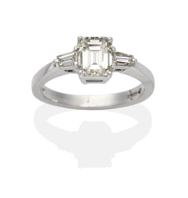 Lot 297 - A Platinum Diamond Solitaire Ring, an octagonal cut diamond between tapered baguette cut...