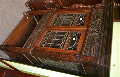 Lot 1410 - A carved oak display cabinet with leaded glass doors bearing a label 'Made of old wood from a...