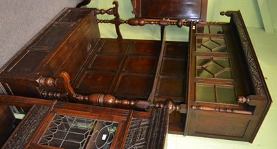 Lot 1411 - An interesting oak settle, with a superstructure incorporating a glazed cabinet to the top,...