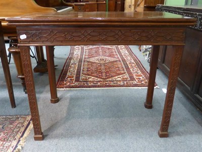 Lot 1445 - A 19th century mahogany card table with blind fret carved detailing