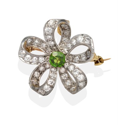 Lot 302 - A Demantoid Garnet and Diamond Scroll Brooch/Pendant, a round cut demantoid garnet in a white...