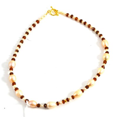 Lot 5009 - A garnet and peach colour cultured pearl necklace