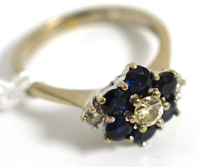 Lot 5024 - A diamond and sapphire cluster ring, stamped '18ct'