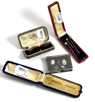 Lot 5028 - Three opal set stick pins, an opal bar brooch, another stick pin and loose opals