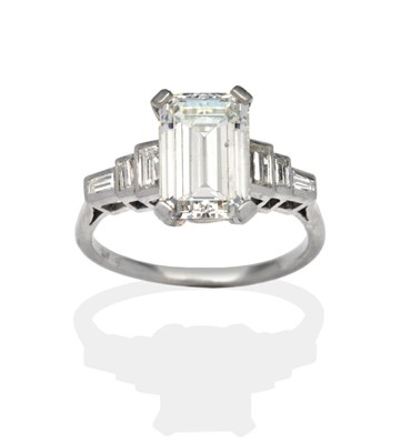 Lot 313 - A Solitaire Diamond Ring, an octagonal cut diamond in a white claw setting, to stepped...