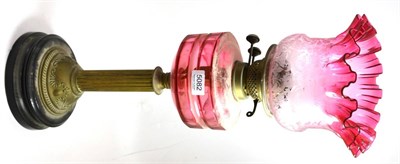 Lot 5082 - A 19th century brass oil lamp with cranberry font and shade