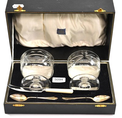 Lot 5094 - A cased preserve set comprising, two cut glass bowls, two silver spoons and a preserve knife