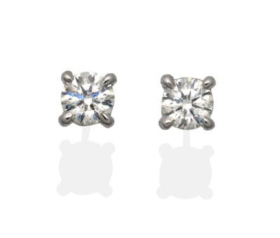 Lot 316 - A Pair of 18 Carat White Gold Diamond Solitaire Earrings, a round brilliant cut diamond in a...