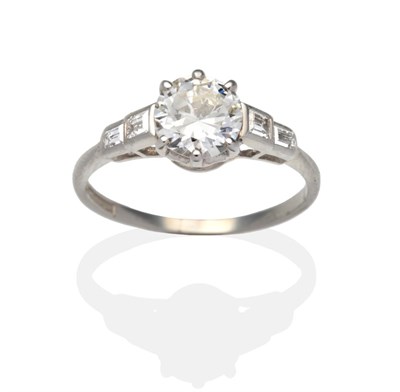 Lot 318 - A Diamond Solitaire Ring, an old cut diamond in a white claw setting to shoulders each set with...