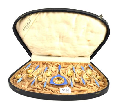 Lot 5120 - A set of twelve Continental silver gilt and enamel coffee spoons and strainer