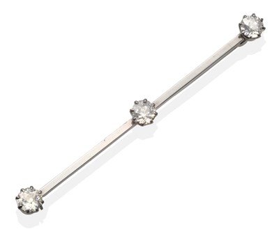 Lot 324 - A Diamond Bar Brooch, three old cut diamonds in white claw settings to a flat sided bar, total...