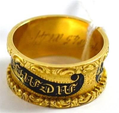 Lot 5182 - An 18ct gold mourning ring, enamelled in black to read 'In memory of', and inscribed to the...