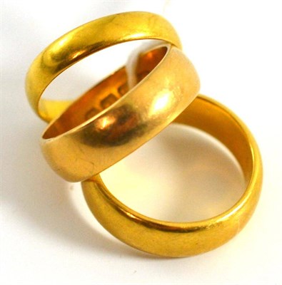 Lot 5191 - Two 22ct gold band rings and 18ct gold band ring