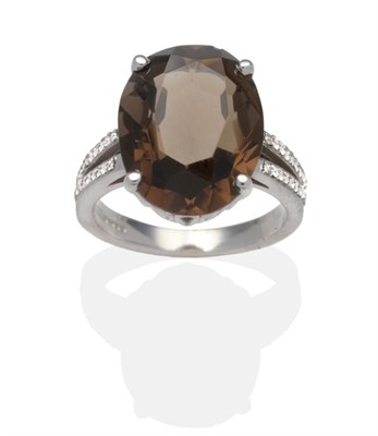 Lot 332 - An 18 Carat White Gold Smokey Quartz and Diamond Ring, an oval cut smokey quartz in a claw...