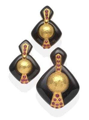 Lot 339 - A Black Enamel and Ruby Brooch/Pendant and Earring Suite, an enamel plaque suspends a larger enamel