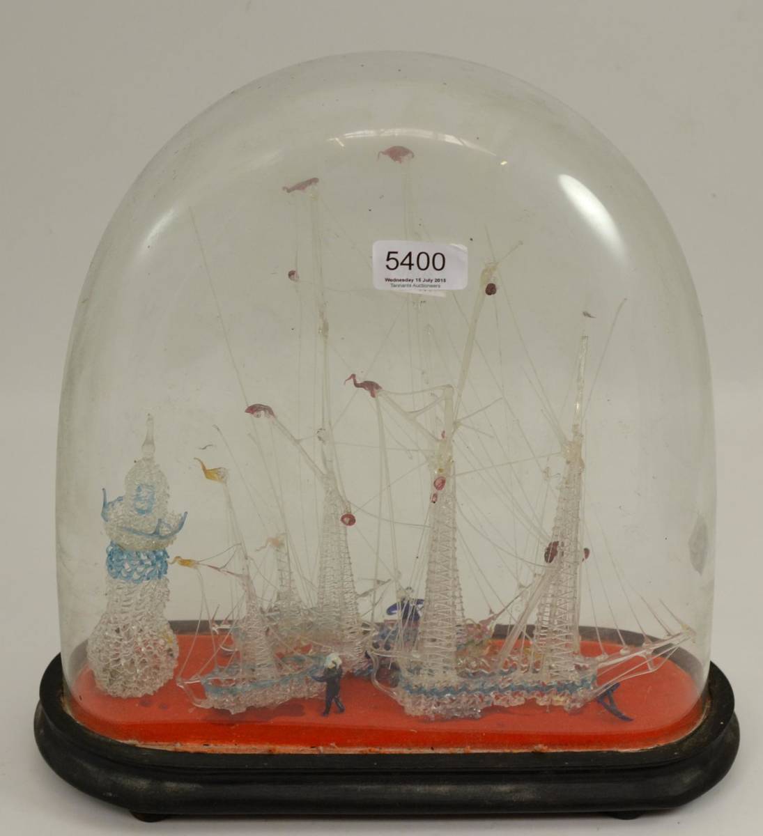 Lot 5400 - A Victorian glass frigger modelled as four ships near a lighthouse, under a glass dome