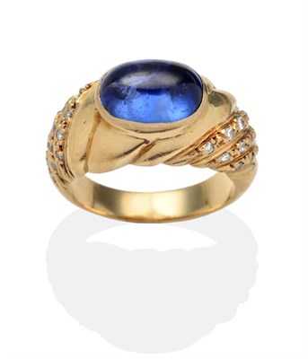 Lot 356 - A Sapphire and Diamond Ring, an oval cabochon sapphire in a yellow rubbed over setting to...