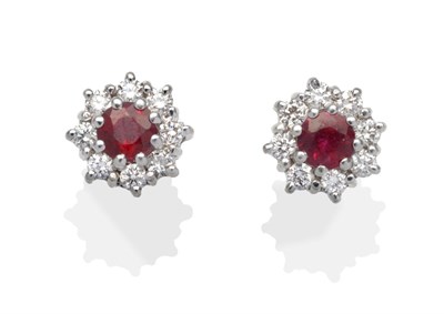 Lot 359 - A Pair of 18 Carat White Gold Ruby and Diamond Cluster Earrings, a round cut ruby within a...