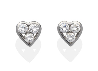 Lot 365 - A Pair of 18 Carat White Gold Diamond Set Heart Shaped Earrings, each set with three round...