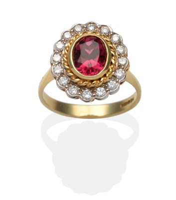 Lot 373 - An 18 Carat Gold Ruby and Diamond Cluster Ring, an oval cut ruby in a yellow rubbed over...